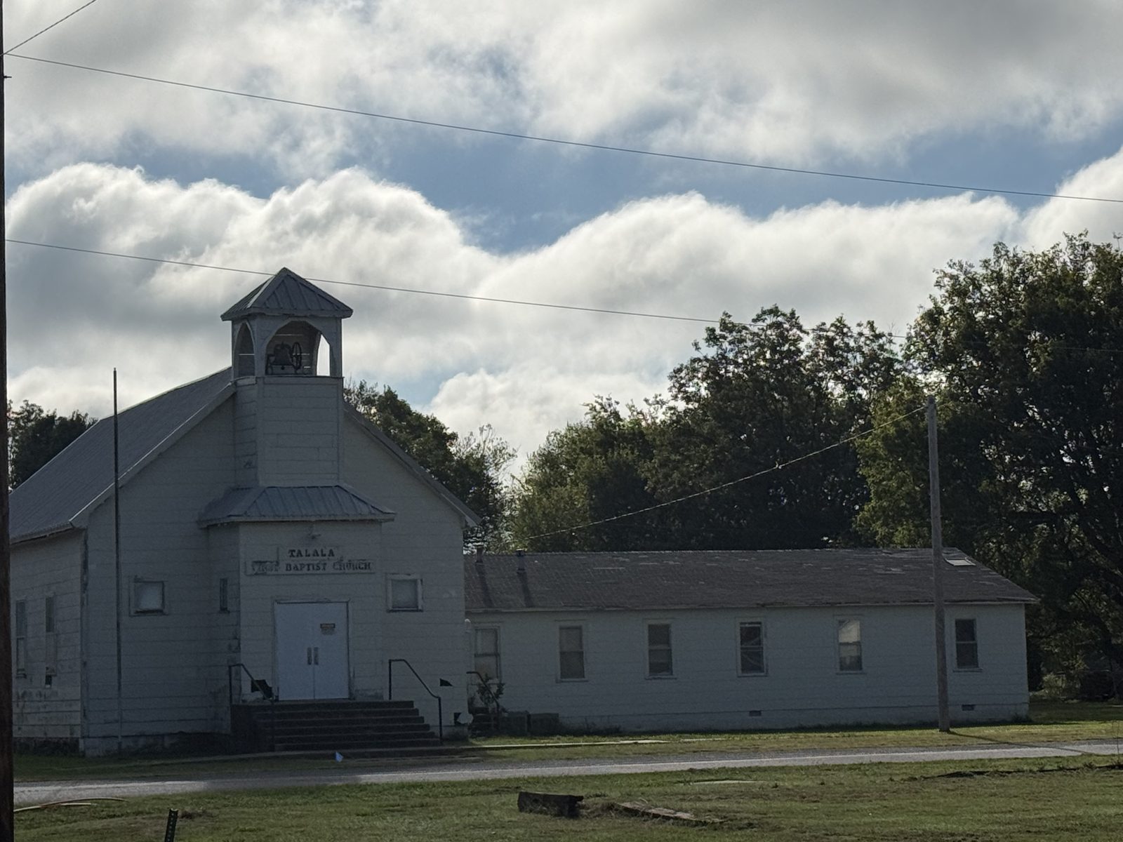 Talala First Baptist Church, a white building with a bell tower