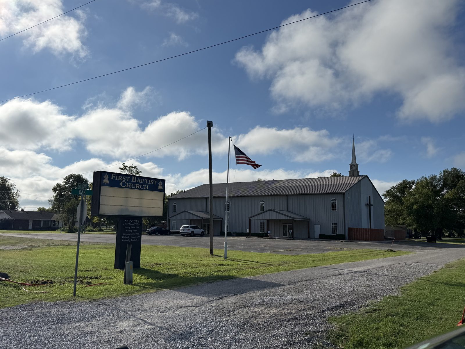 Talala First Baptist Church, wide exterior of the building and roadside sign