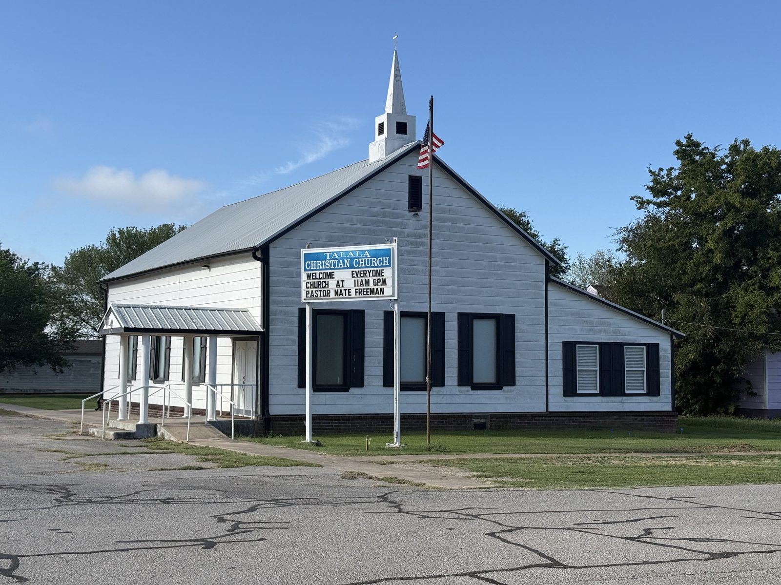 Talala Christian Church, a white building with a steeple and marquee sign