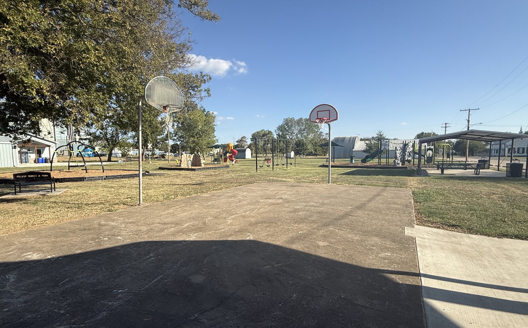 Basketball court at Town Park with playground beyond