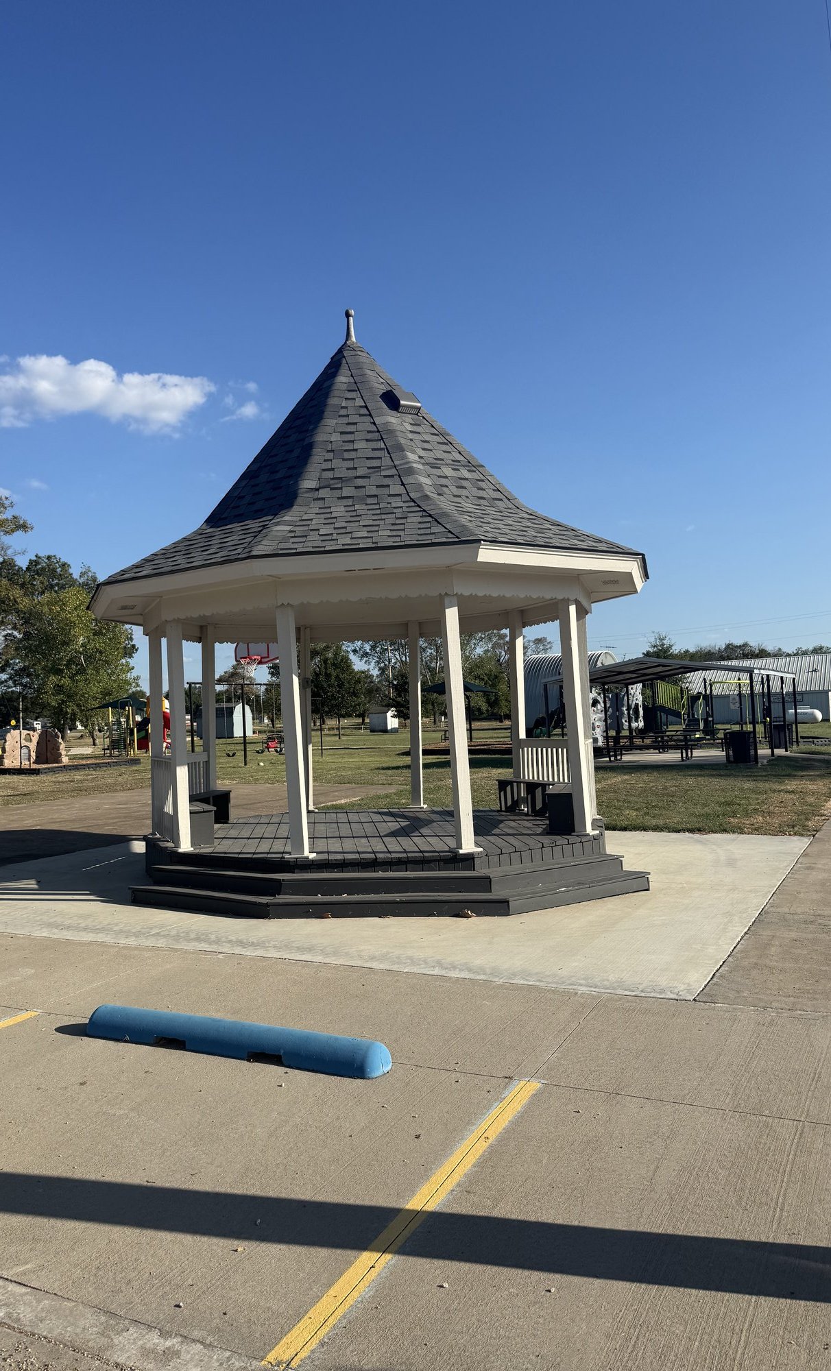 Octagonal white gazebo with gray roof at Town Park